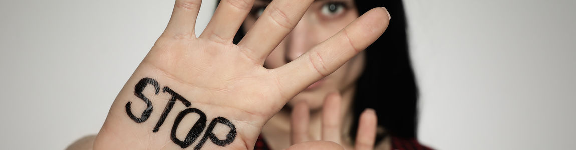 ragazza che mostra la mano con la scritta stop