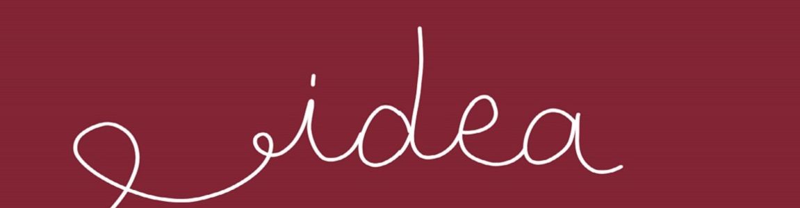 parola idea scritta in corsivo su fondo rosso