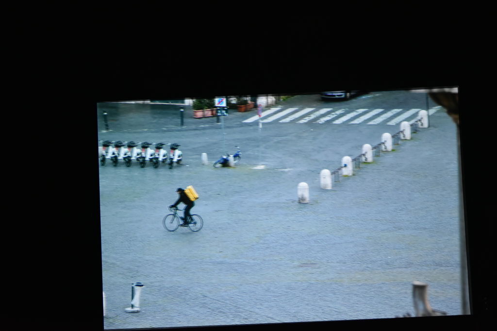 Un fotogramma del documentario; un ragazzo in bicicletta dentro Roma deserta preso dall'alto 